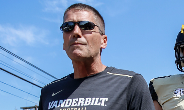 Vanderbilt offensive coordinator Andy Ludwig walks ahead of Vanderbilt (45) Cody Markel (TE) during...