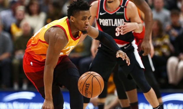 Utah Jazz guard Donovan Mitchell (45) loses control of the ball after being fouled by Portland Trai...