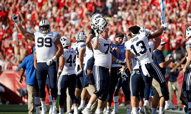 BYU Cougars players react on the sideline prior to the start of the fourth quarter of the game agai...