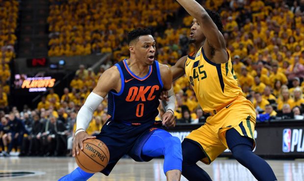 Donovan Mitchell #45 of the Utah Jazz guards against Russell Westbrook #0 of the Oklahoma City Thun...