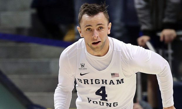 Brigham Young Cougars guard Nick Emery dribbles down the court during NCAA basketball against the P...