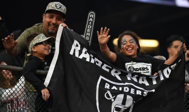 Fans cheer in the stands during their NFL game between the Oakland Raiders and the Los Angeles Char...