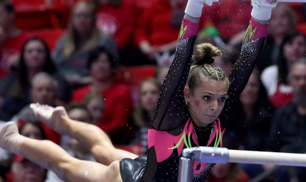 The University of Utah's Hunter Dula performs on the bars during the Red Rocks' meet against the Un...