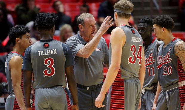 Utah Utes head coach Larry Krystkowiak talks with his players during a timeout as Utah and Colorado...