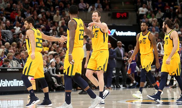 Jazz players walk off the floor at a time out after a Utah Jazz forward Royce O'Neale (23) three po...