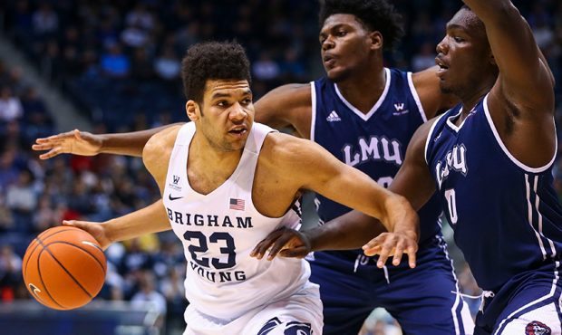 Brigham Young Cougars forward Yoeli Childs (23) is guarded by Loyola Marymount Lions players while ...