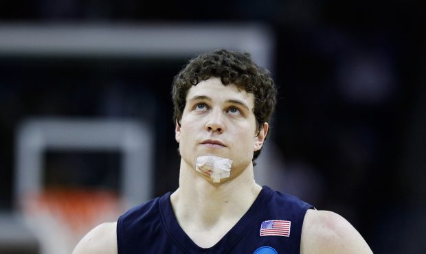 Jimmer Fredette #32 of the Brigham Young Cougars looks on with a bandage on his chin during the sec...