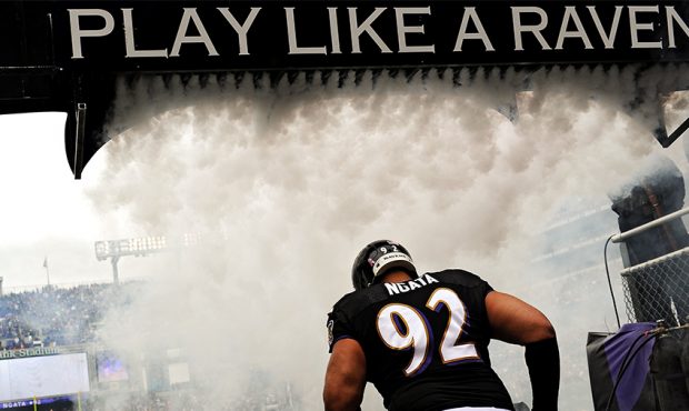 Haloti Ngata runs through smoke as he is introduced before playing the Green Bay Packers at M&T Ban...