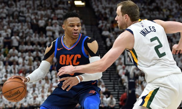 Russell Westbrook #0 of the Oklahoma City Thunder tries to drive past the defense of Joe Ingles #2 ...