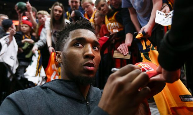 Utah Jazz guard Donovan Mitchell (45) signs a ball for a fan after beating the Minnesota Timberwolv...