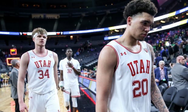 Utah forward Timmy Allen, right, and teammates leave the court after loss to the Oregon Ducks in Pa...