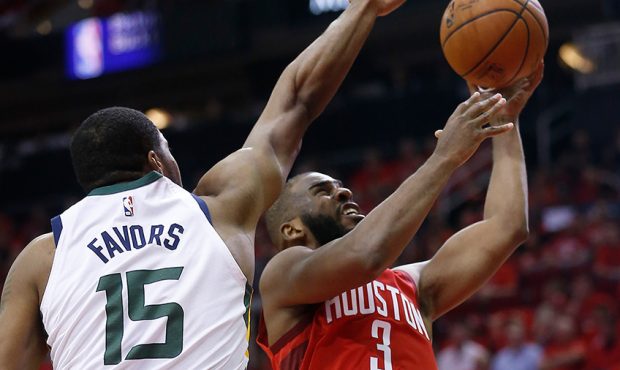 Chris Paul #3 of the Houston Rockets drives past Derrick Favors #15 of the Utah Jazz during Game On...