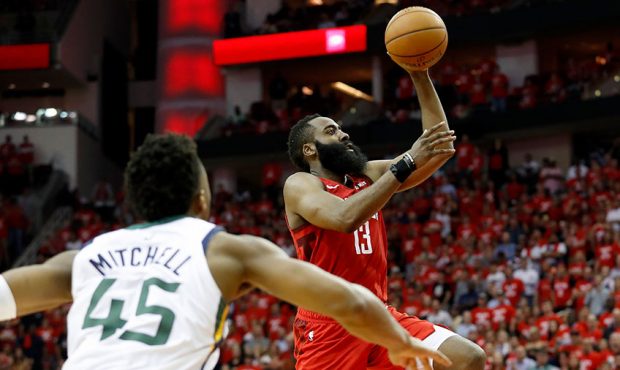 James Harden #13 of the Houston Rockets goes up for a shot defended by Donovan Mitchell #45 of the ...