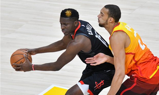 Clint Capela #15 of the Houston Rockets controls the ball in front of Rudy Gobert #27 of the Utah J...