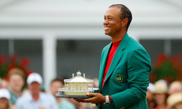 Tiger Woods of the United States celebrates with the Masters Trophy during the Green Jacket Ceremon...