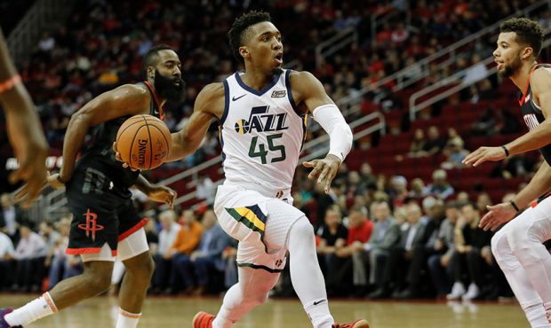 Donovan Mitchell #45 of the Utah Jazz drives to the basket defended by Michael Carter-Williams #1 o...