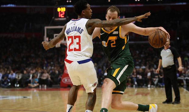 Lou Williams #23 of the Los Angeles Clippers defends against the dribble of Joe Ingles #2 of the Ut...