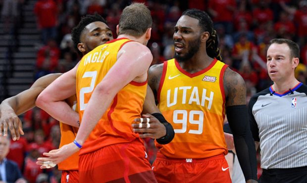 Donovan Mitchell #45 and Jae Crowder #99 restrain Joe Ingles #2 of the Utah Jazz after a technical ...