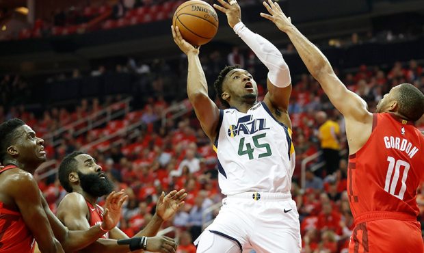 Donovan Mitchell #45 of the Utah Jazz shoots the ball defended by Eric Gordon #10 of the Houston Ro...