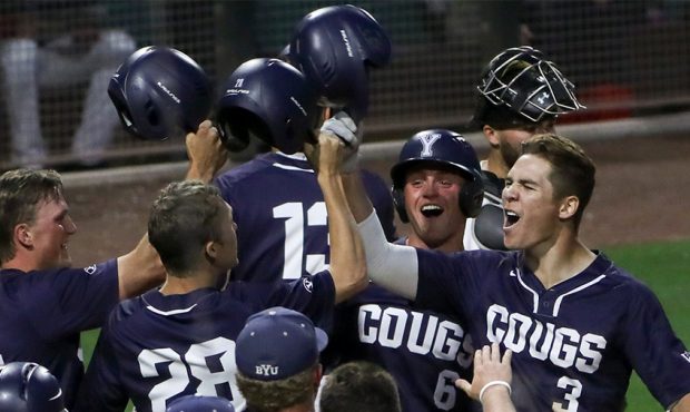 BYU’s Danny Gelalich, left, celebrates at the plate after he blasted a grand slam in the eighth i...