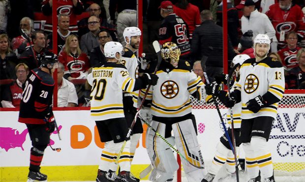 Tuukka Rask #40 of the Boston Bruins celebrates with his teammates after defeating the Carolina Hur...
