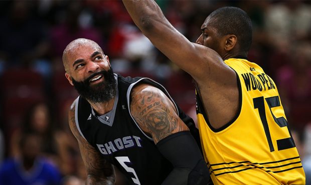 Carlos Boozer #5 of the Ghost Ballers handles the ball while being guarded by Metta World Peace #15...