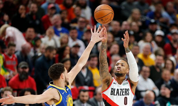 Damian Lillard #0 of the Portland Trail Blazers shoots the ball against Klay Thompson #11 of the Go...
