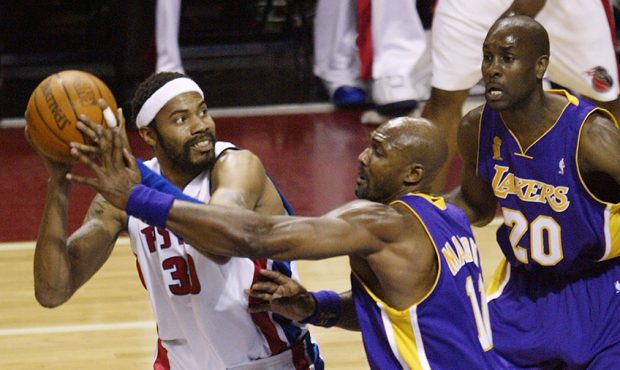 Rasheed Wallace #3 of the Detroit Pistons looks for an opening around the defense of Gary Payton #2...