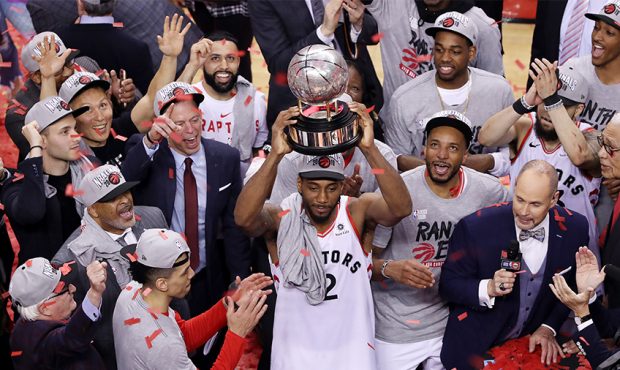 Kawhi Leonard #2 of the Toronto Raptors celebrates with the Eastern Conference Finals trophy after ...