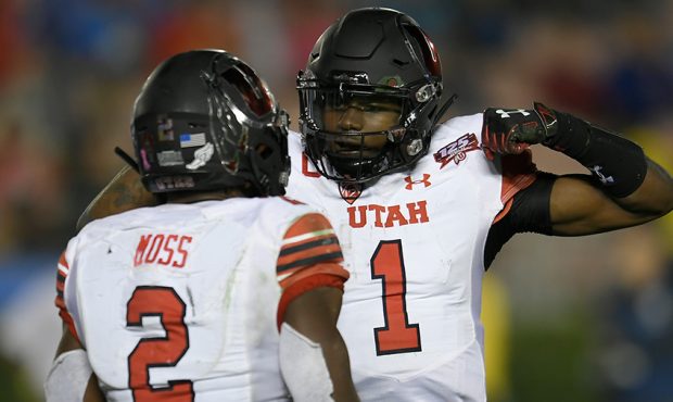 Zack Moss #2 and Tyler Huntley #1 of the Utah Utes celebrate after a touchdown in the second half a...