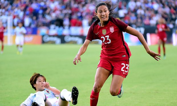 Christen Press #23 of the United States chases after a ball in front of Yuka Momiki #15 of Japan du...
