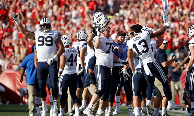 BYU Cougars players react on the sideline prior to the start of the fourth quarter of the game agai...