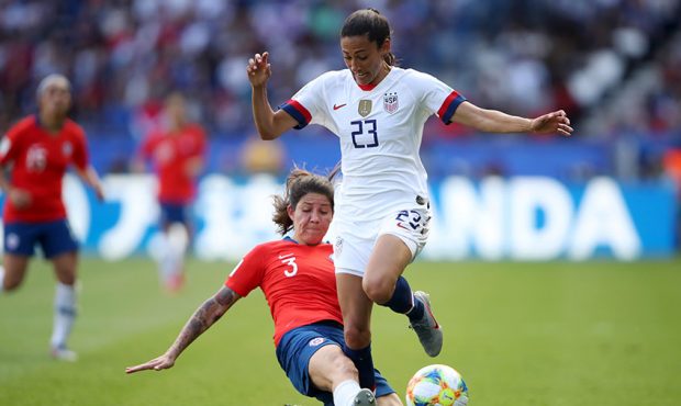 Carla Guerrero of Chile tackles Christen Press of the USA during the 2019 FIFA Women's World Cup Fr...