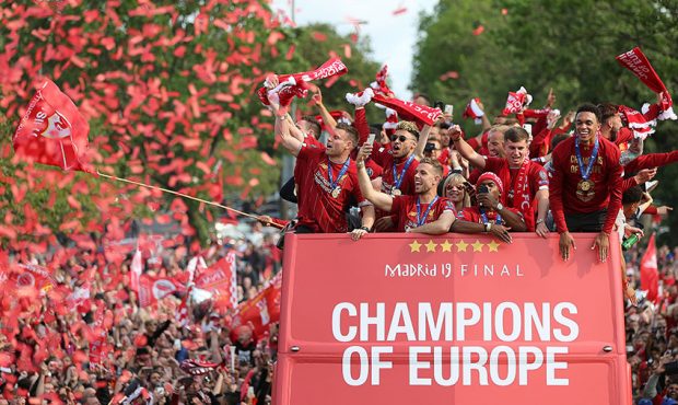 Liverpool's players with the UEFA Champions League trophy on board a parade bus after winning the U...