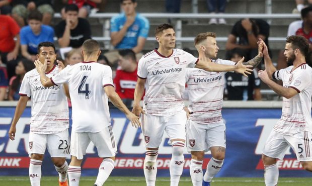 Real Salt Lake midfielder Albert Rusnak, second from right, celebrates with teammates after scoring...