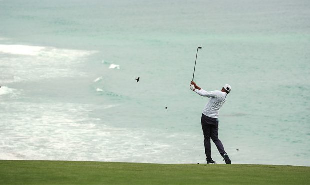 Tony Finau of the United States plays his second shot on the par 4,...
