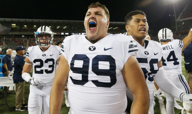 BYU defensive lineman Zac Dawe (99) cheers after the Cougars defeated the Arizona Wildcats 28-23 in...