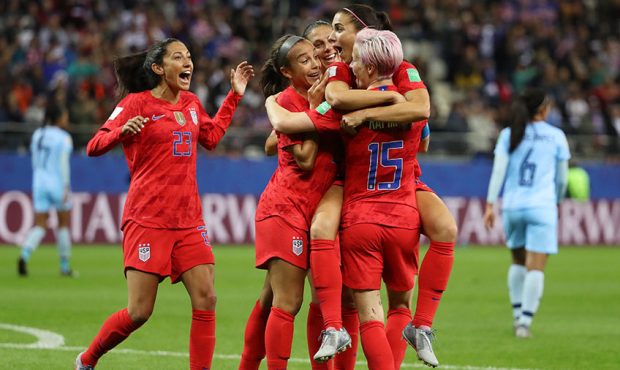 Alex Morgan of the USA celebrates with teammates after scoring her team's twelfth goal during the 2...