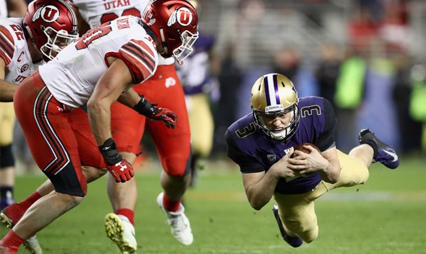 Jake Browning #3 of the Washington Huskies dives for a first down against the Utah Utes during the ...