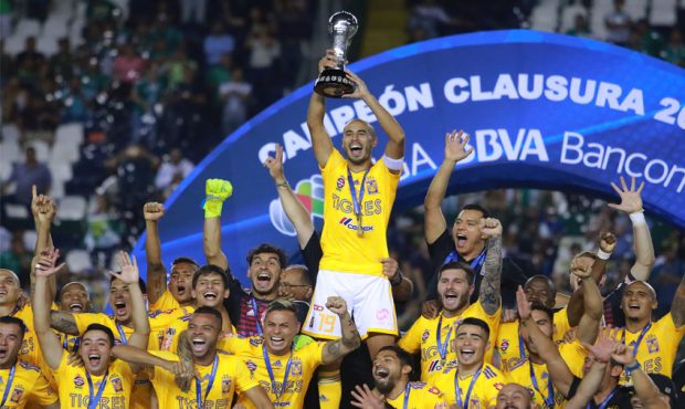 LEON, MEXICO - MAY 26: Guido Pizarro (C) of Tigres lifts the Championship Trophy to celebrate with ...