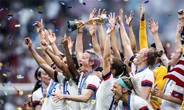 YON, FRANCE - JULY 07: Megan Rapinoe of the USA lifts the FIFA Women's World Cup Trophy following h...