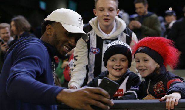 Donovan Mitchell of the USA Basketball team greets fans ahead of the round 23 AFL match between the...