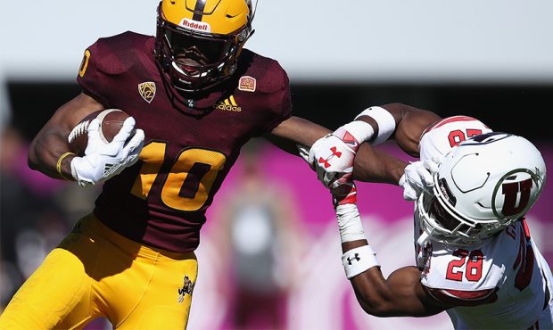 Wide receiver Kyle Williams #10 of the Arizona State Sun Devils avoids a tackle from defensive back...