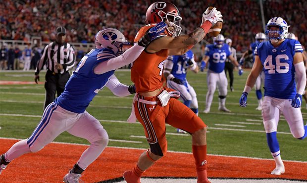 Samson Nacua #45 of the Utah Utes catches this second half touchdown pass in front of Matthew Cridd...