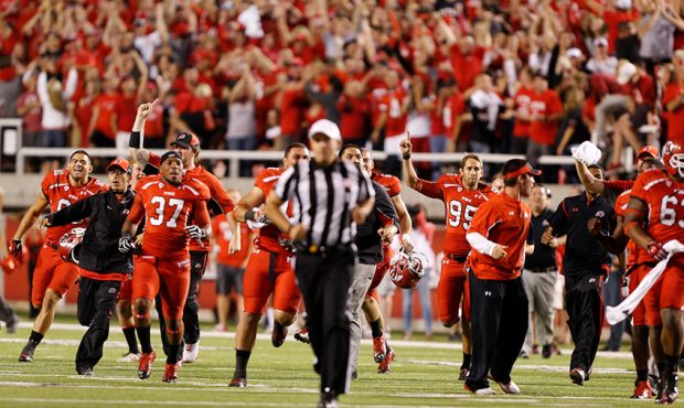 University of Utah Utes Players rush the field after the BYU Cougars had an inculpate pass the was ...