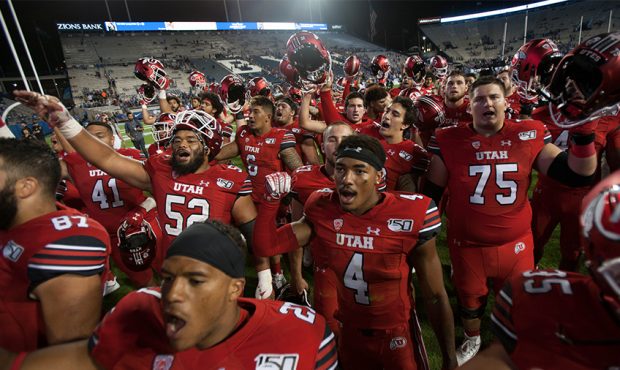 Members of the Utah Utes sing their fight song after winning their game against the BYU Cougars at ...