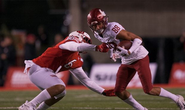 Rodrick Fisher #88 of the Washington State Cougars breaks a tackle attempt by Bradlee Anae #6 of th...