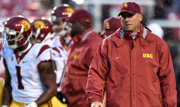 Head coach Clay Helton of the USC Trojans watches practice in the rain prior to their game against ...