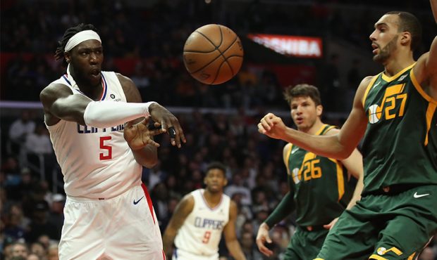 Montrezl Harrell #5 of the Los Angeles Clippers passes the ball past Rudy Gobert #27 of the Utah Ja...