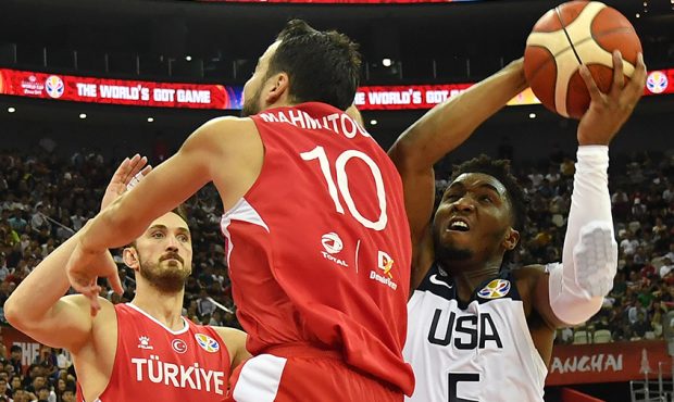 Donovan Mitchell (R) of the US tries to take a shot during the Basketball World Cup Group E game be...